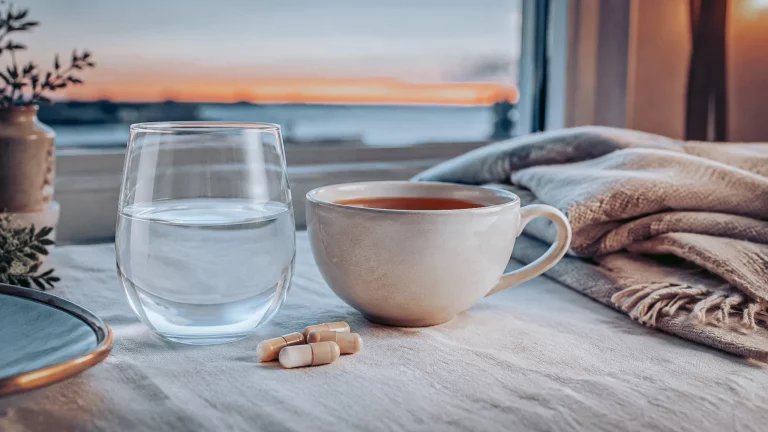 Magnésium de la détente : gélules et verre d'eau dans une ambiance calme du soir